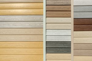 Vinyl siding with imitation wood texture in bright palette of colors. Plastic wall covering for exterior decoration of house. Abstract background for your design with copy space and place for text